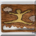 J074. Brass and wood leaping woman pin. - $32 